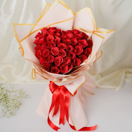 Red rose bouquet wrapped in paper at Ajay Flower Shop, Delhi Cantt